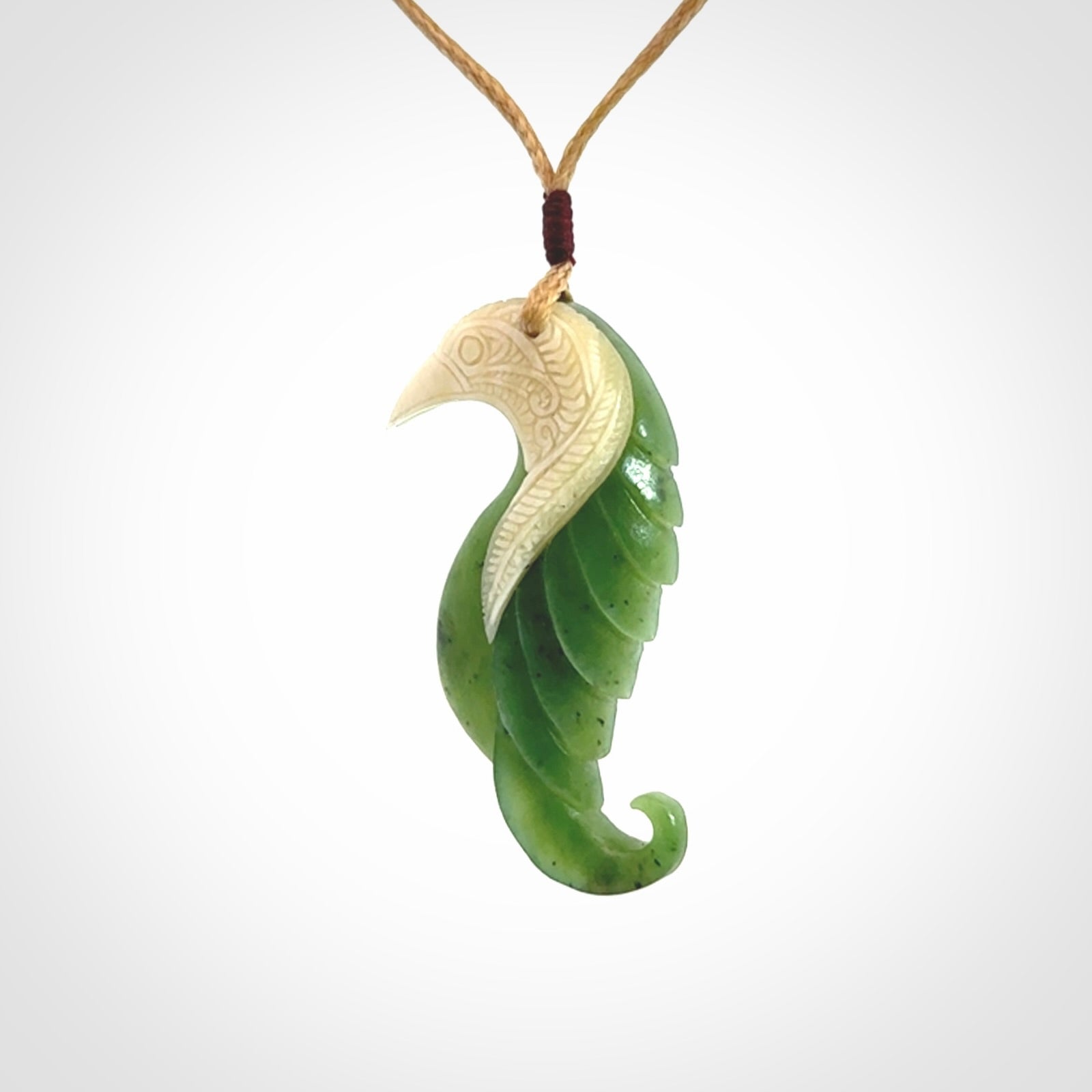Hand carved jade and bone bird pendant