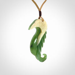 Hand carved jade and bone bird pendant
