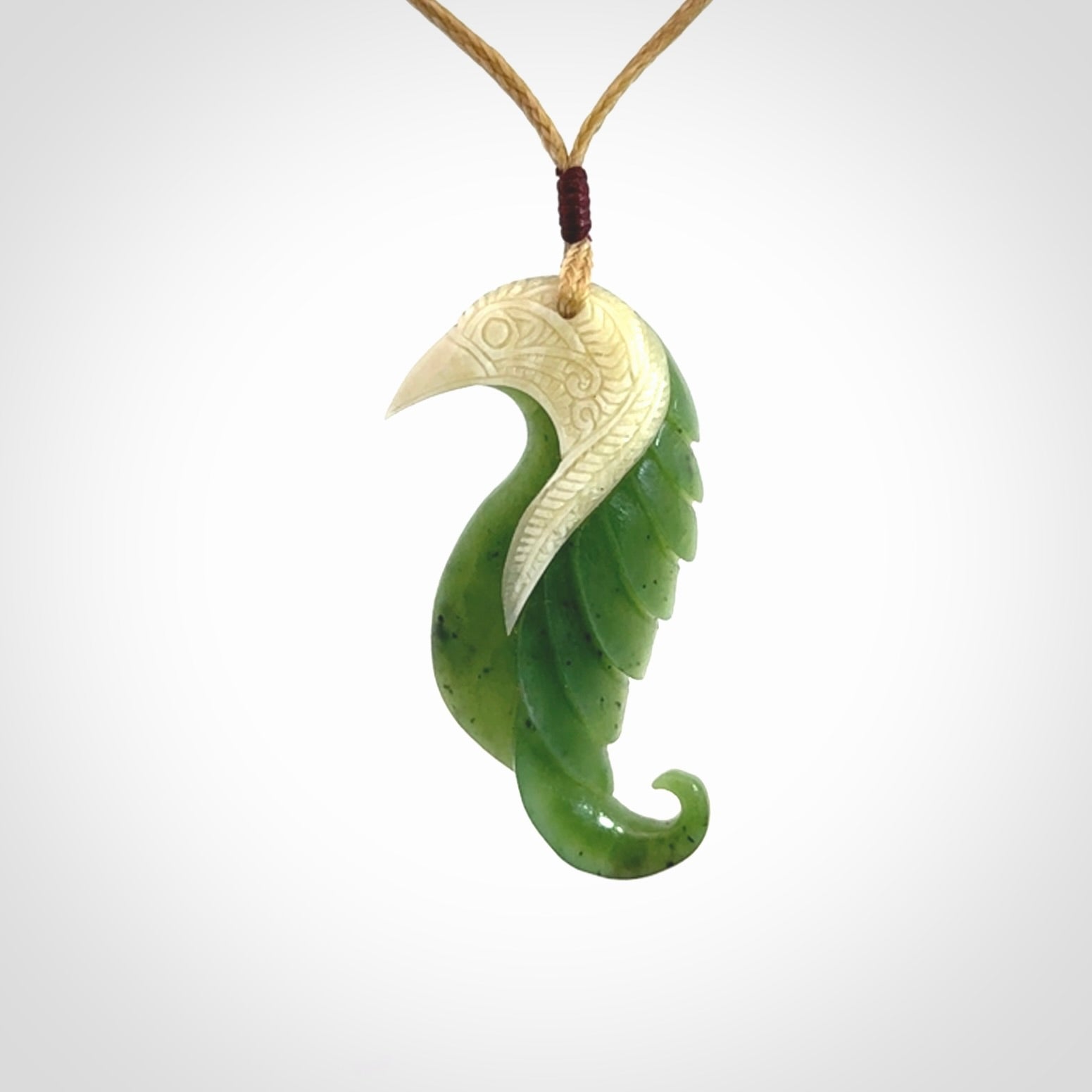 Hand carved jade and bone bird pendant