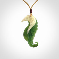 Hand carved jade and bone bird pendant