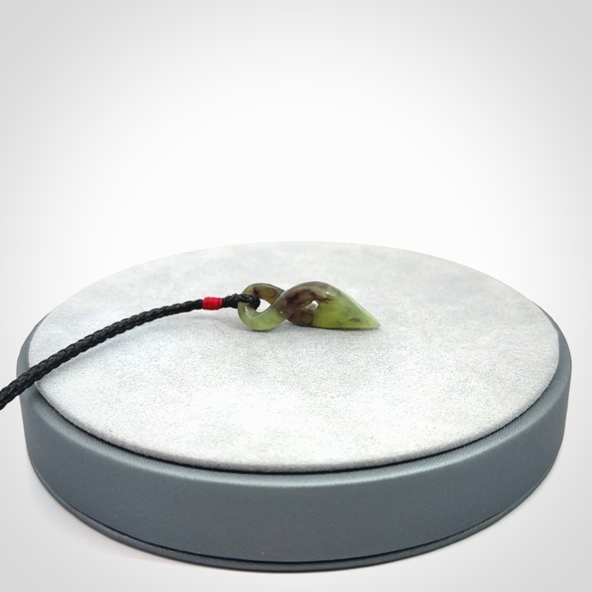 A Fine Twist Pendant, Carved in Totoweka Jade