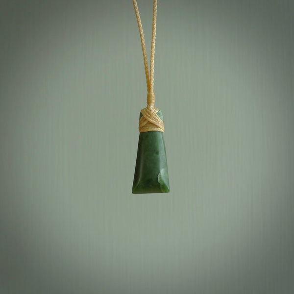 Hand carved jade toki by Ric Moor. Made in New Zealand by NZ Pacific. Hand carved Toki pendants crafted from beautiful New Zealand Pounamu, Jade. We deliver these with Express Courier, on adjustable cords.
