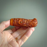 A traditional hand carved Māori Kōauau flute. This piece is made from bone and is a fully functioning musical instrument and can be played. Beautiful ethnic art hand made by NZ Pacific.