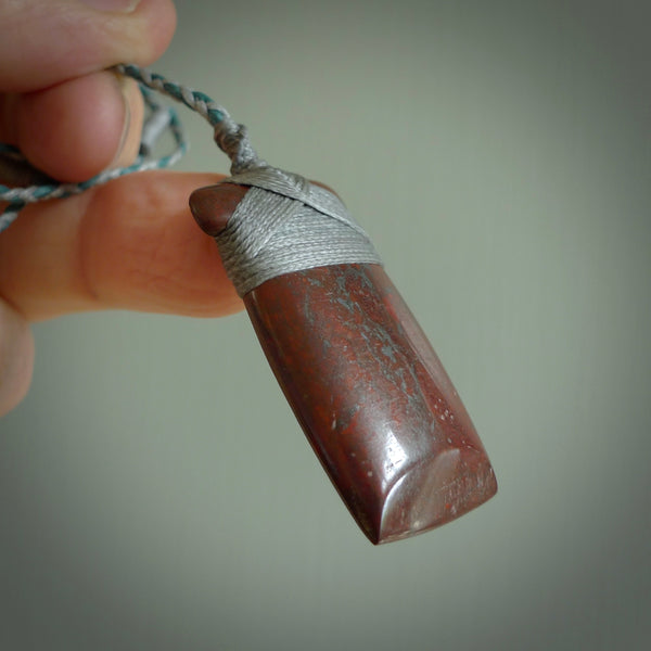 This is a beautiful hand carved Red Jasper Stone toki pendant. A really cool piece that is made from this rare and beautiful material. The red jasper has a very distinctive look and each piece is different. We ship this worldwide and the cost of shipping is included in the price.