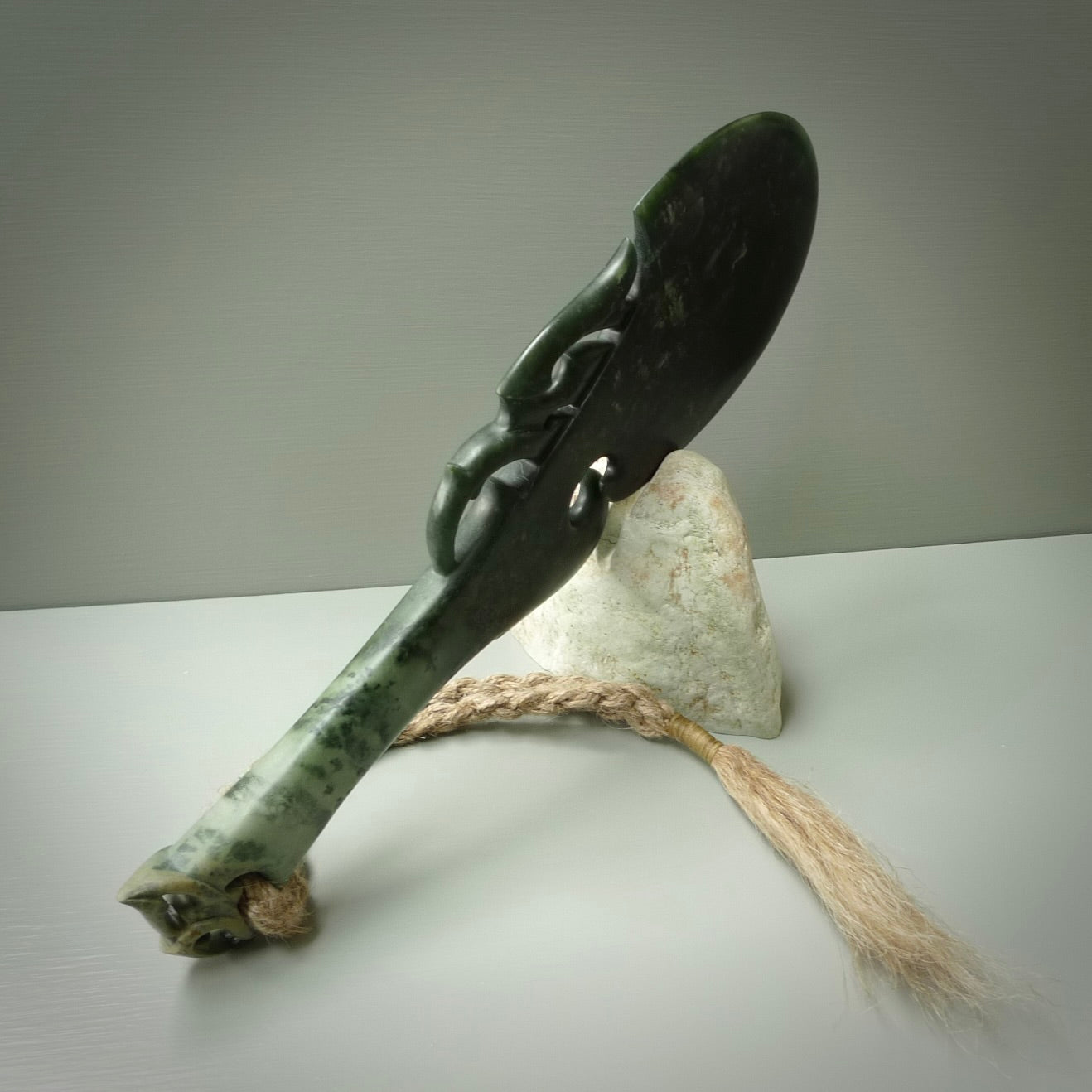 Hand carved wahaika Pounamu. Art to display. One only hand made wahaika display piece with base. New Zealand wahaika carved in Pounamu, Jade by Kerry Thompson. Free delivery worldwide.