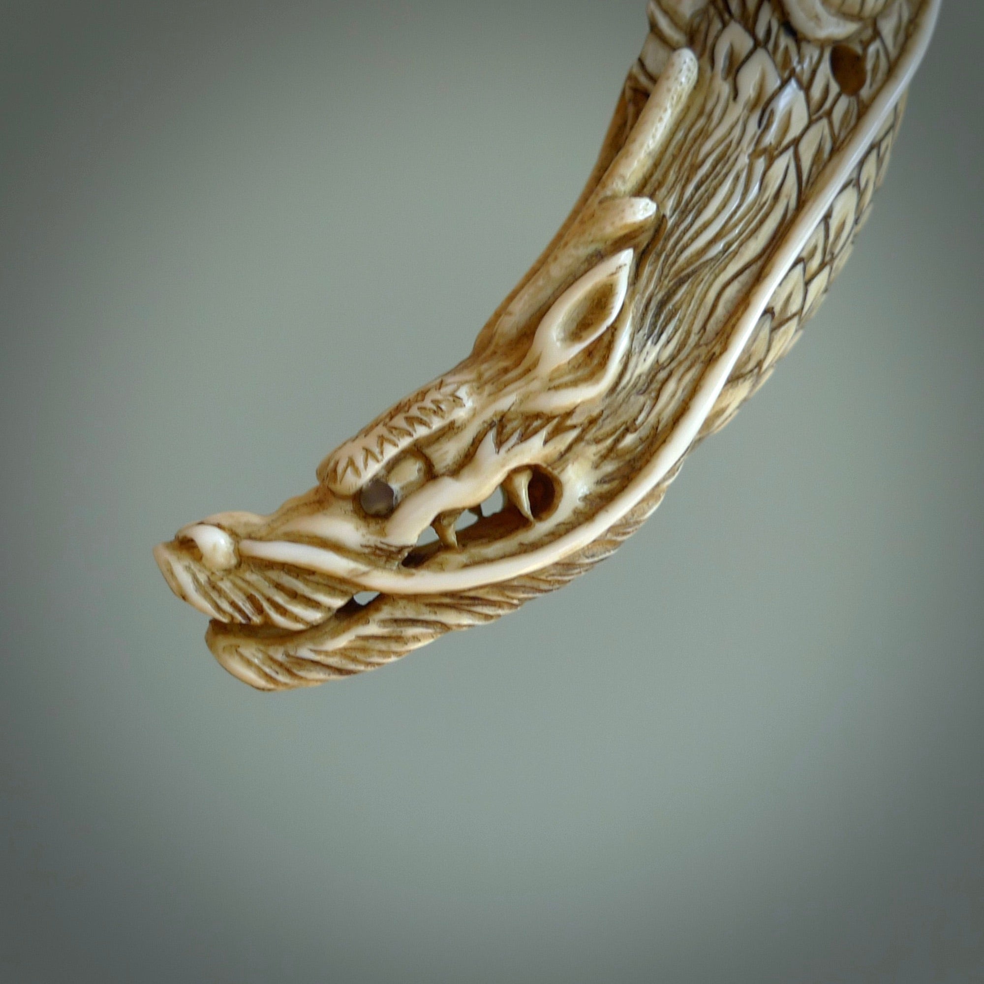 Hand carved dragon Pendant. Made from warthog tusk in New Zealand. Unique dragon necklace hand made from warthog tusk by master bone carver Fumio Noguchi. Spectacular collectable work of art, made to wear. One only pendant, delivered to you at no extra cost with express courier.