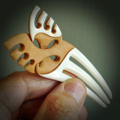A hand carved bone and stained bone Heru comb. A large hand made Heru comb by New Zealand artist Kerry Thompson. Kerry has carved an exquisite work of art and would be perfect for an enthusiasts collection.