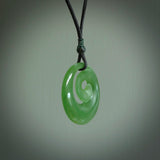 Hand carved New Zealand Inanga jade koru pendant. Carved for NZ Pacific by Ross Crump. Jade jewelry for sale online exclusively with NZ Pacific.