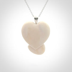 This is a hand carved love heart with love fingers made from bone with sterling silver bale and provided with a sterling silver chain.