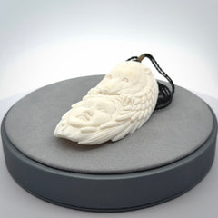 Hand carved woman with bear pendant