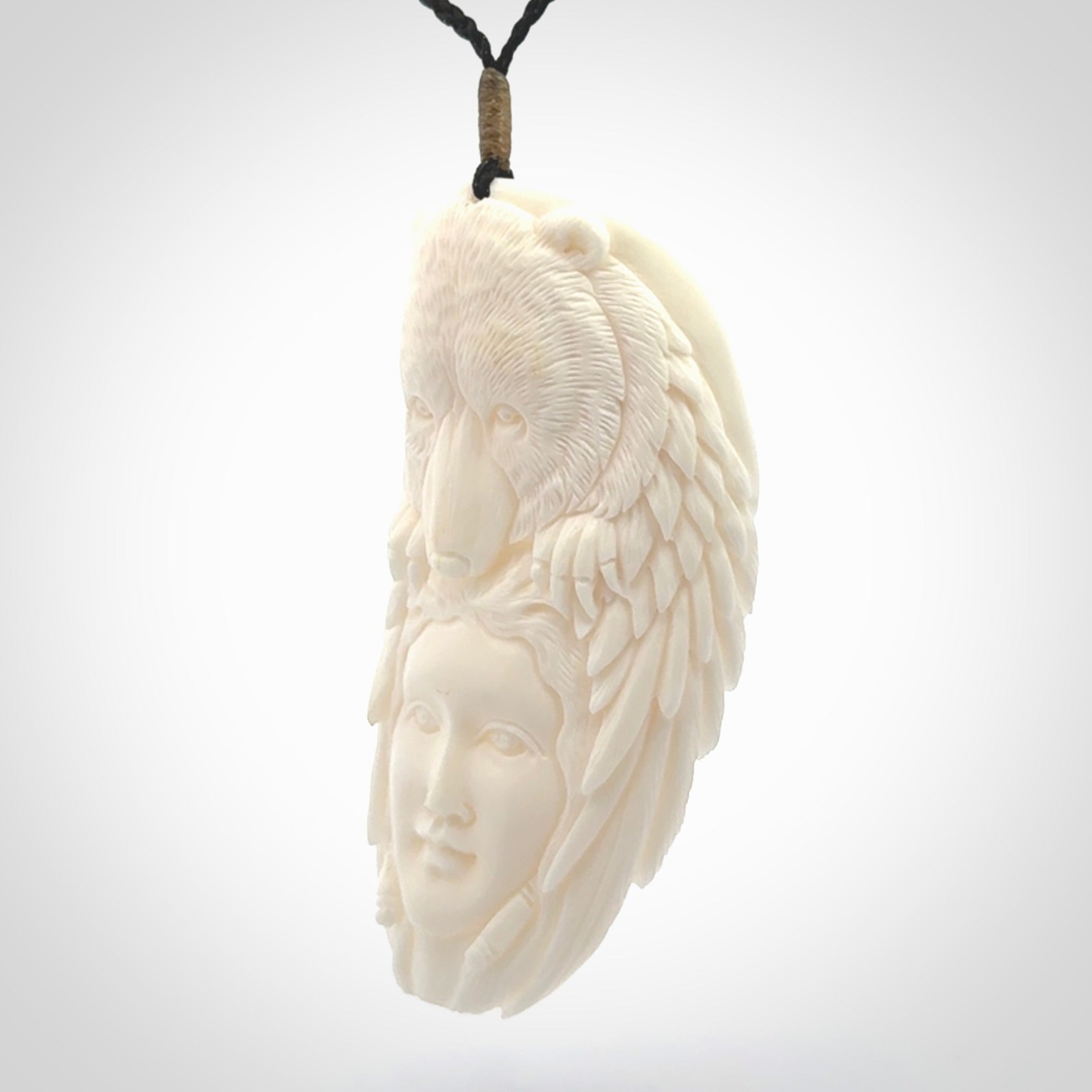 Hand carved woman with bear pendant