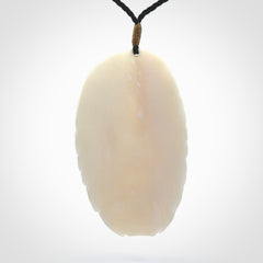 Hand carved woman with bear pendant