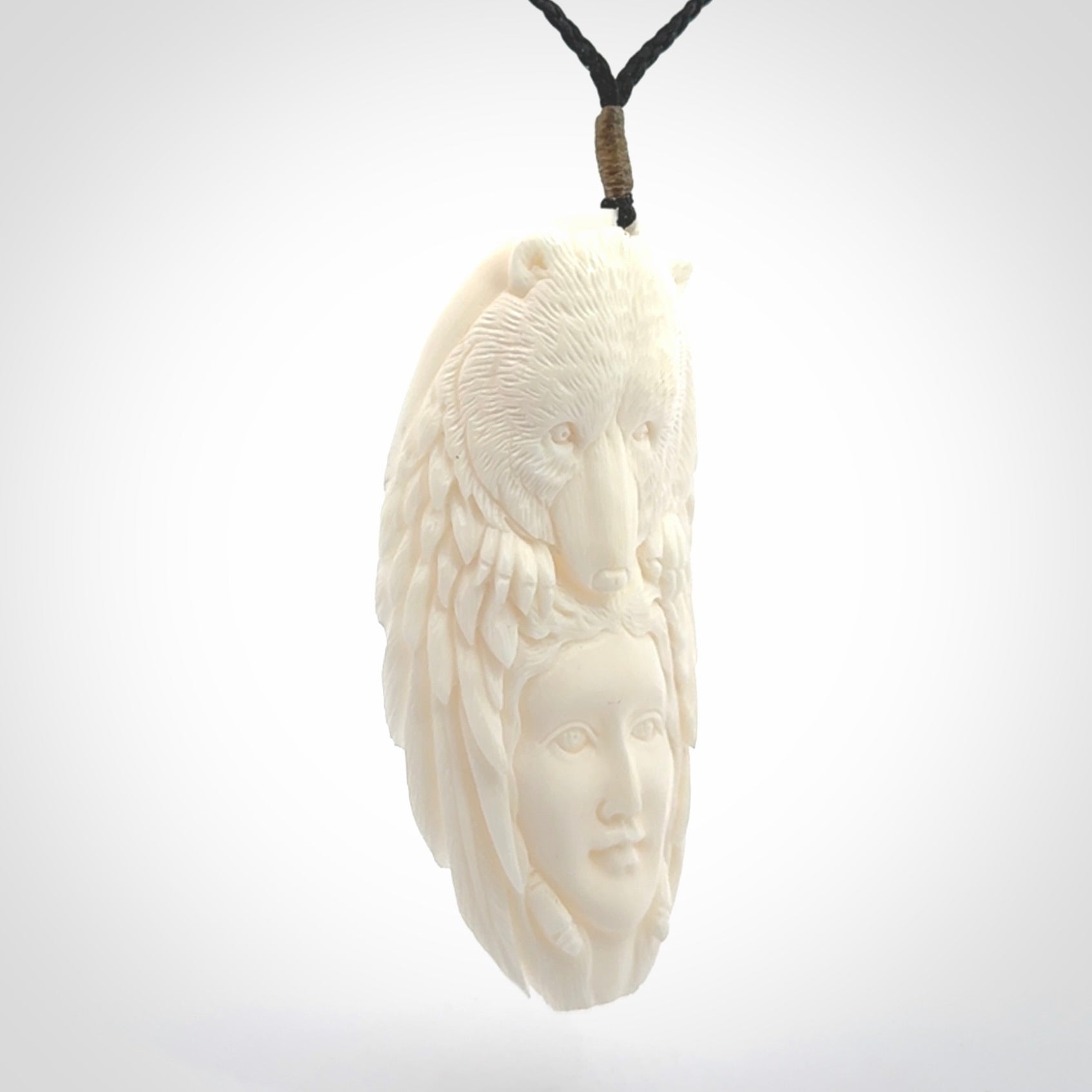 Hand carved woman with bear pendant