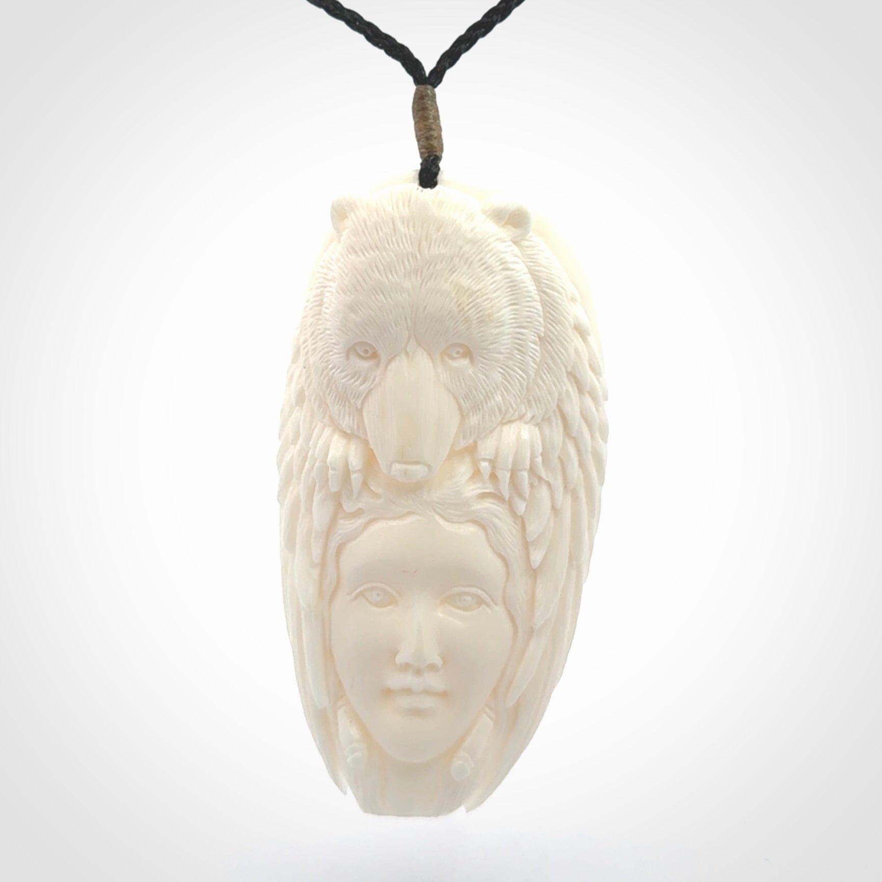 Hand carved woman with bear pendant