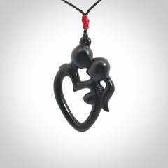 Hand carved Black Jade couples kissing in the shape of a heart pendant. Contemporary design is black jade. Pendants for lovers. Provided with adjustable cord.