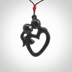 Hand carved Black Jade couples kissing in the shape of a heart pendant. Contemporary design is black jade. Pendants for lovers. Provided with adjustable cord.