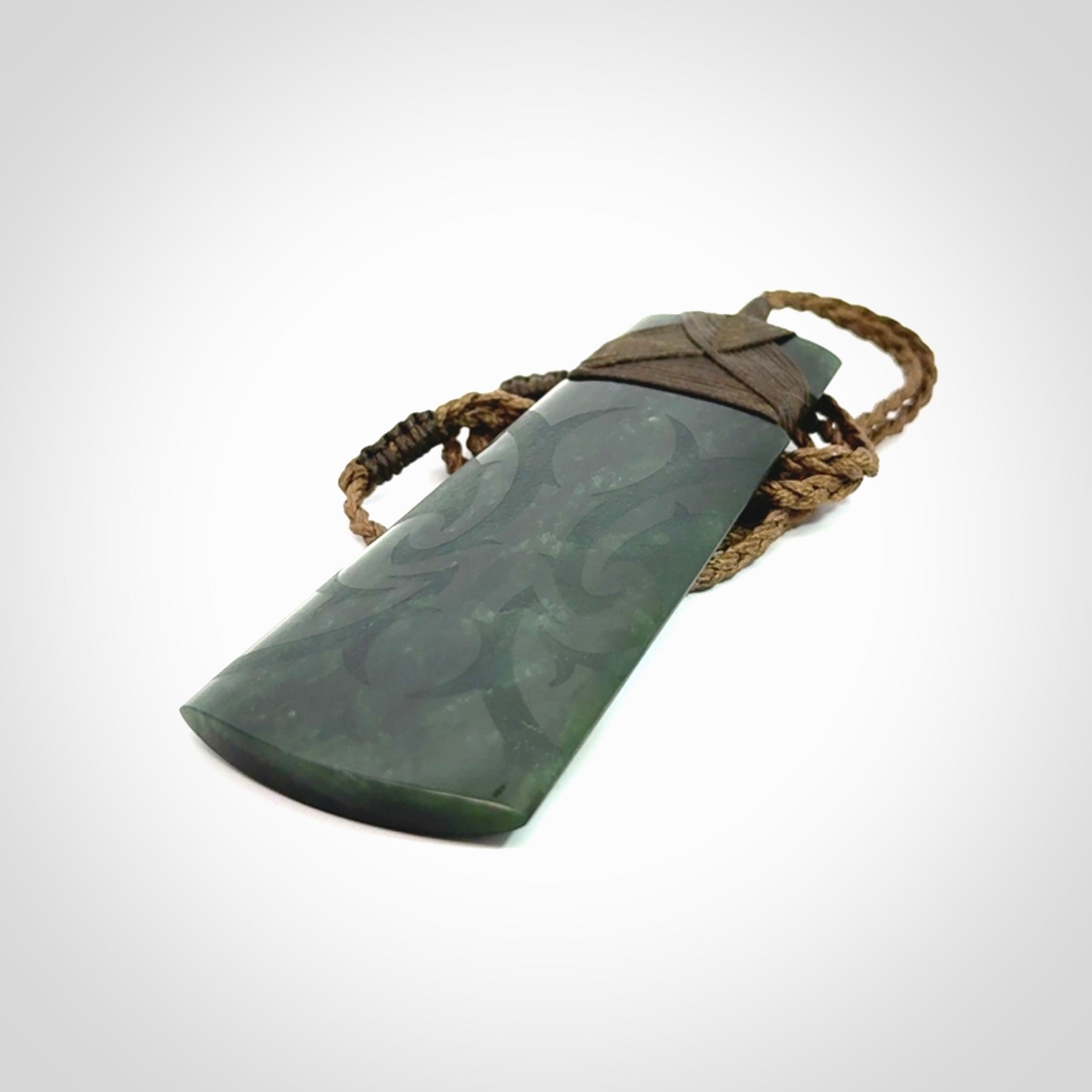 Hand made large New Zealand jade toki with koru pendant. Hand carved in New Zealand by Kerry Thompson. Unique large Jade Toki with adjustable cord.
