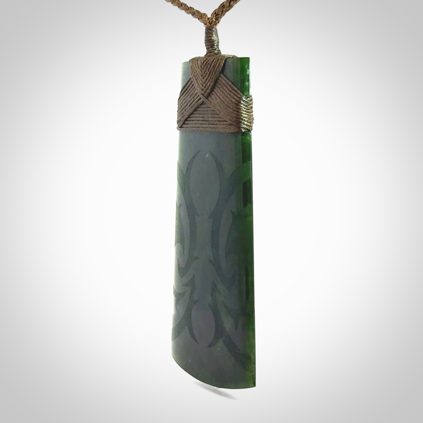 Hand made large New Zealand jade toki with koru pendant. Hand carved in New Zealand by Kerry Thompson. Unique large Jade Toki with adjustable cord.