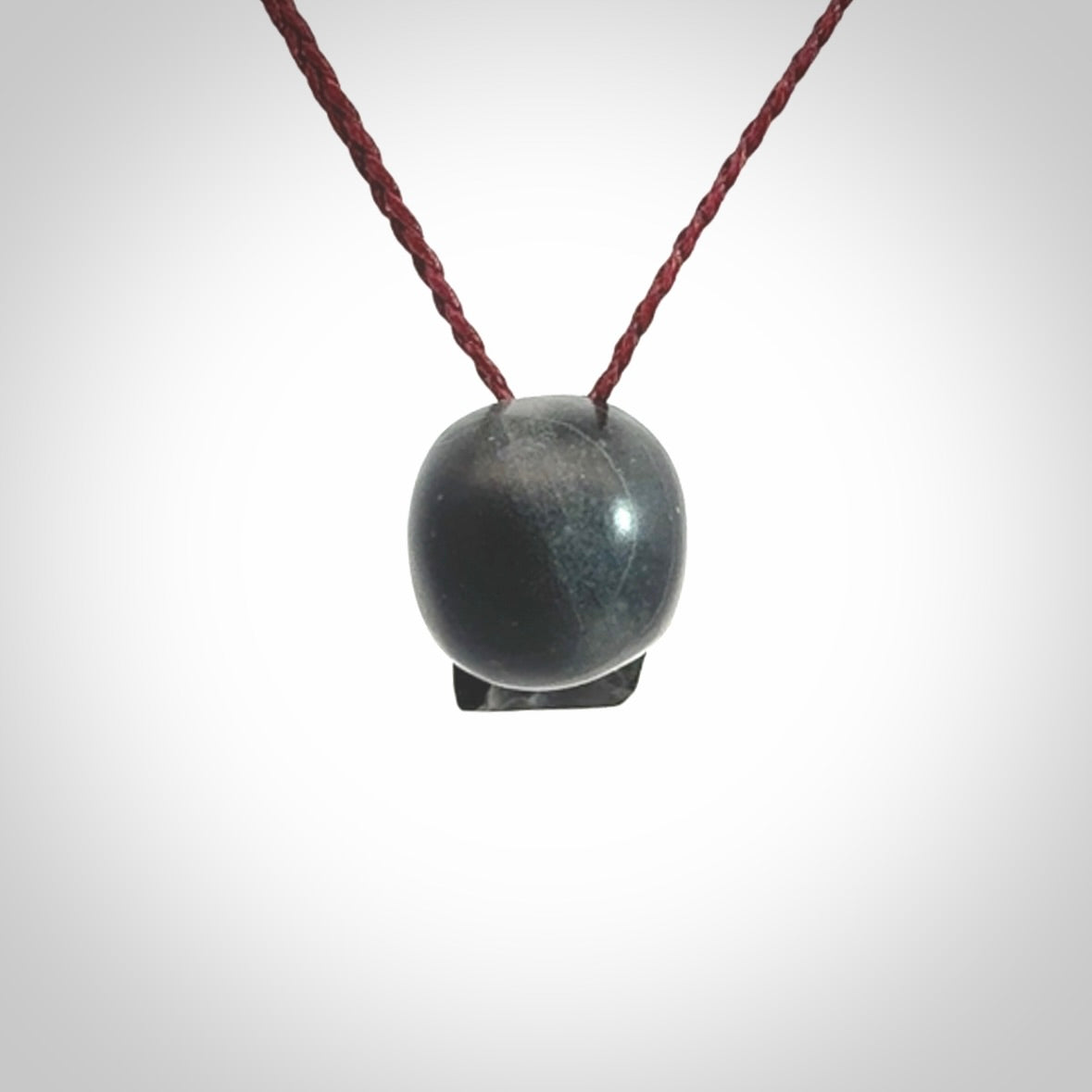This picture shows a small Black Obsidian stone skull pendant that we have hand carved. It is polished to a soft shine and is a very striking piece. Provided with an adjustable plum cord.