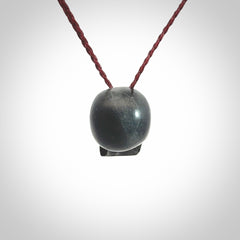 This picture shows a small Black Obsidian stone skull pendant that we have hand carved. It is polished to a soft shine and is a very striking piece. Provided with an adjustable plum cord.