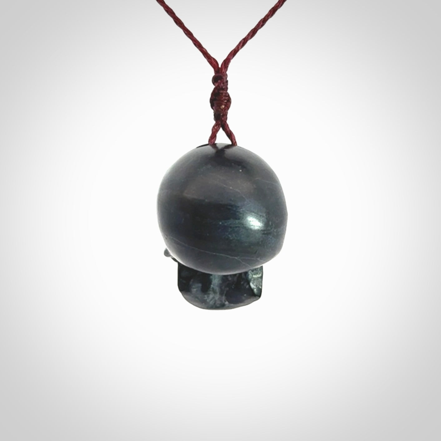 This picture shows a Black Obsidian stone skull pendant that we have hand carved. It is polished to a soft shine and is a very striking piece. Provided with an adjustable plum cord.