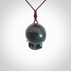 This picture shows a Black Obsidian stone skull pendant that we have hand carved. It is polished to a soft shine and is a very striking piece. Provided with an adjustable plum cord.