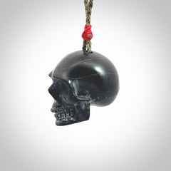 This picture shows a large Black Obsidian stone skull pendant that we have hand carved. It is polished to a soft shine and is a very striking piece. Provided with an adjustable khaki cord.