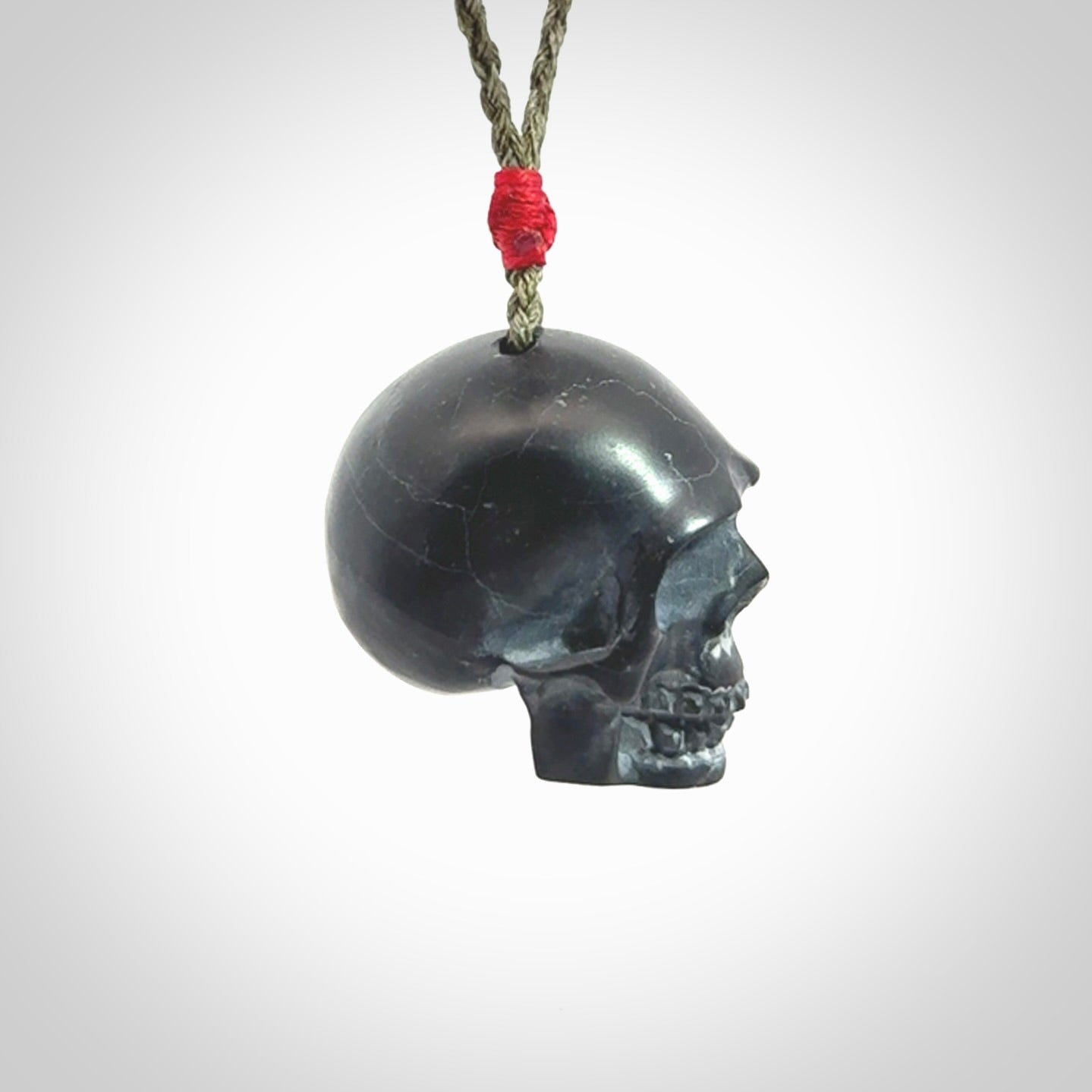 This picture shows a large Black Obsidian stone skull pendant that we have hand carved. It is polished to a soft shine and is a very striking piece. Provided with an adjustable khaki cord.
