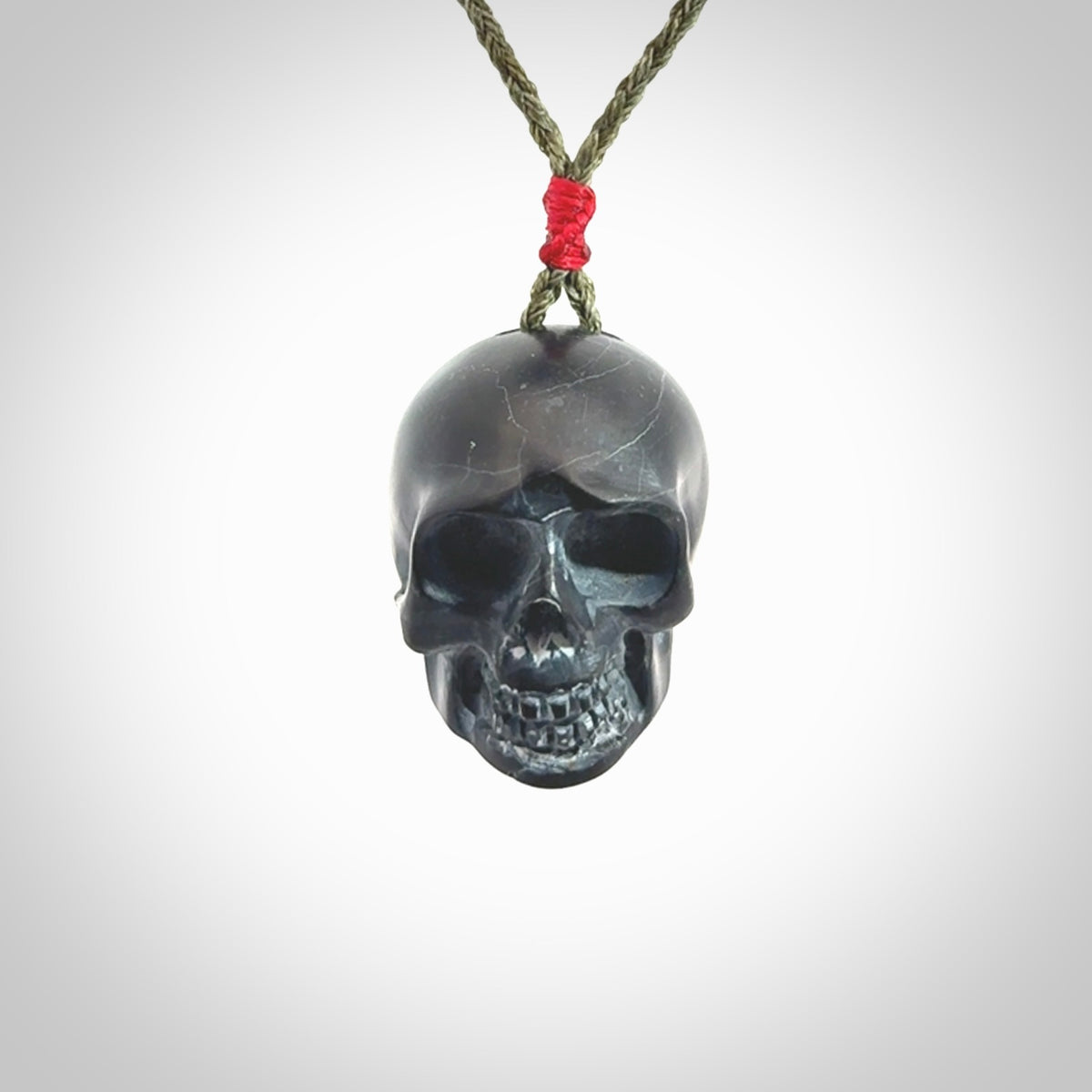 This picture shows a large Black Obsidian stone skull pendant that we have hand carved. It is polished to a soft shine and is a very striking piece. Provided with an adjustable khaki cord.