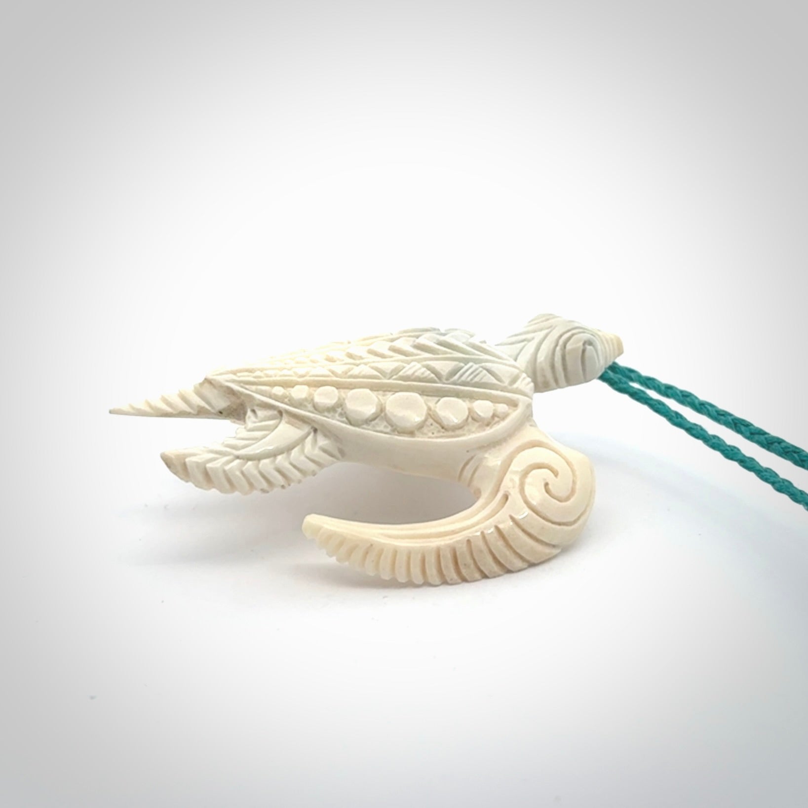 Hand carved bone turtle pendant. Delivered with an adjustable blue cord and packaged in a woven kete pouch.