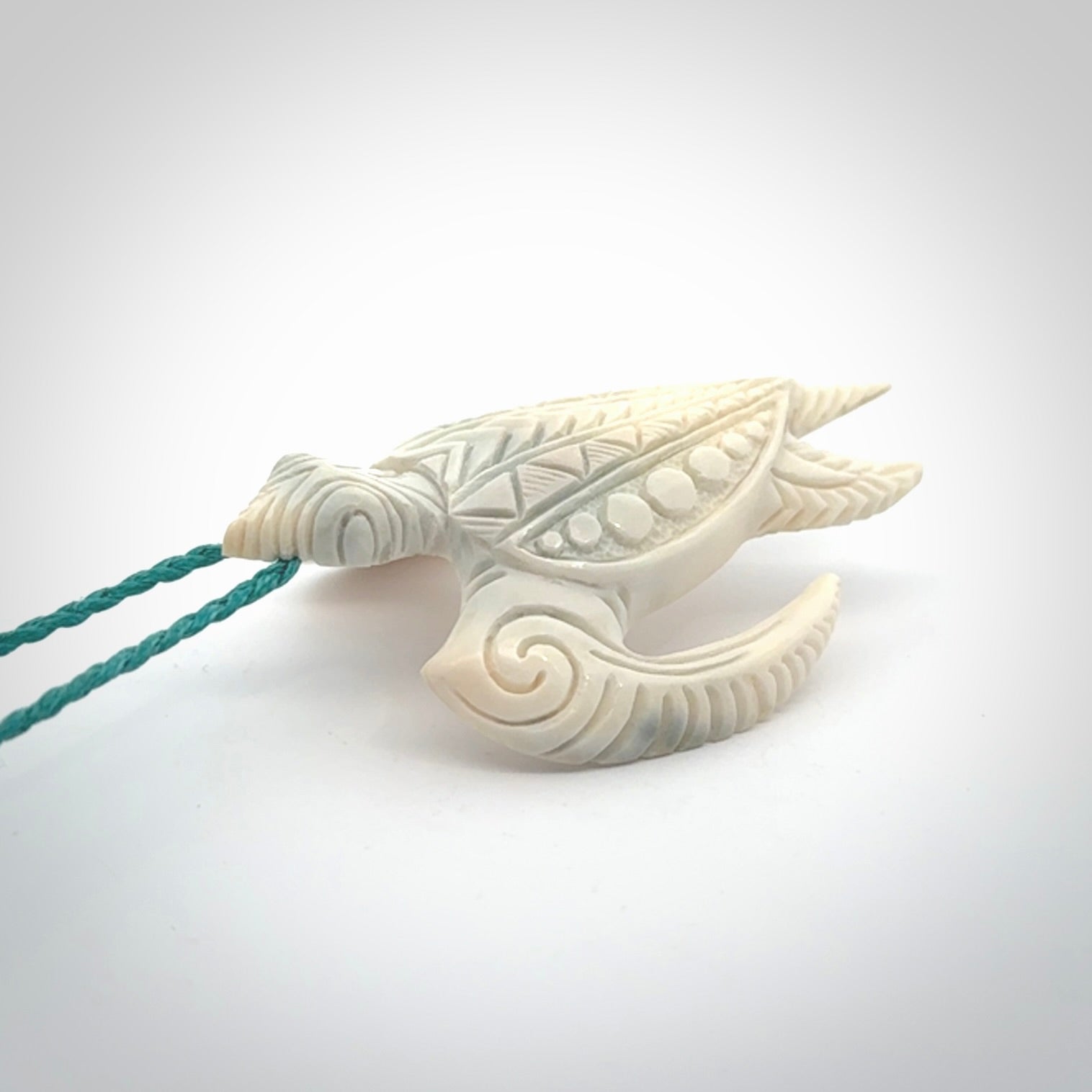 Hand carved bone turtle pendant. Delivered with an adjustable blue cord and packaged in a woven kete pouch.