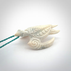 Hand carved bone turtle pendant. Delivered with an adjustable blue cord and packaged in a woven kete pouch.
