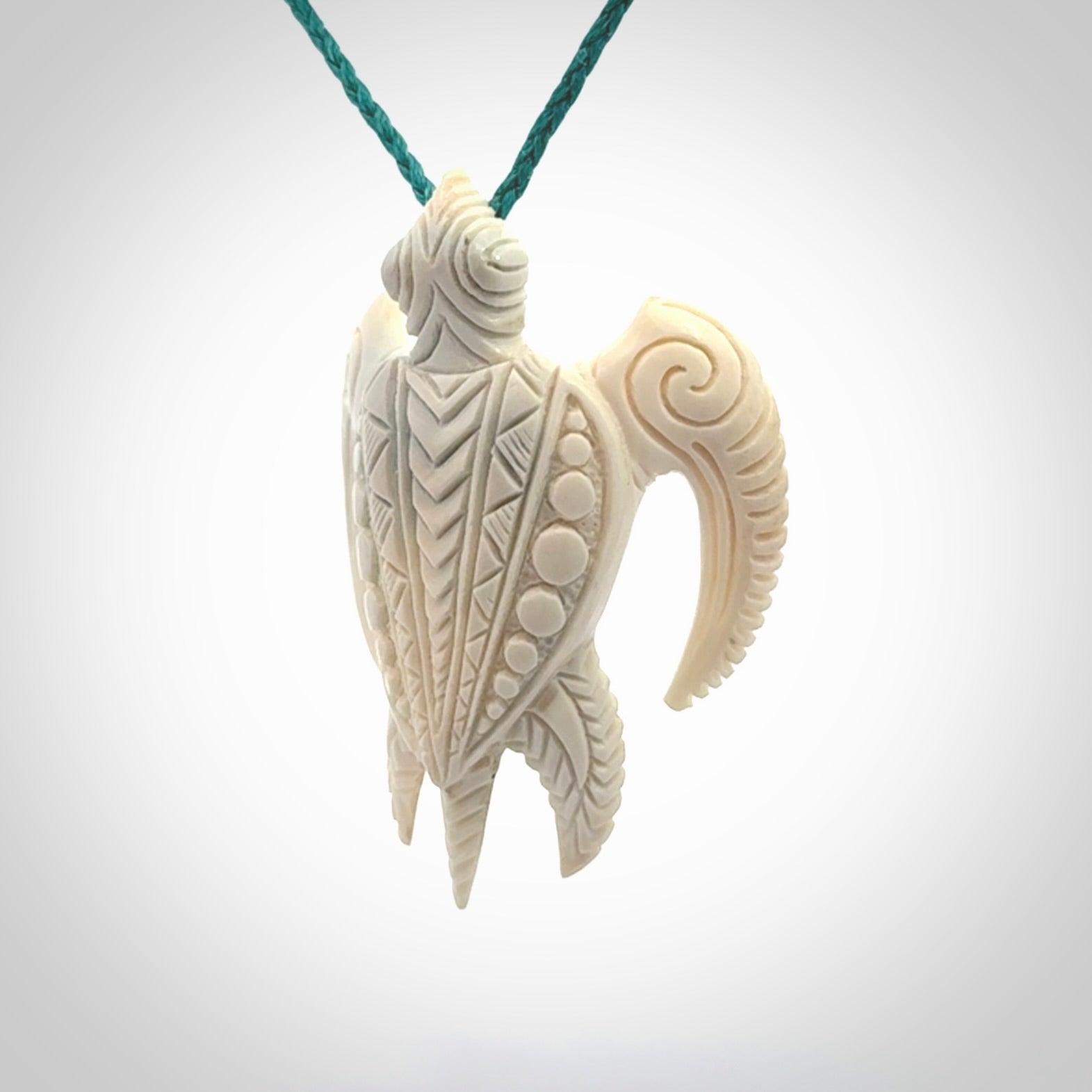 Hand carved bone turtle pendant. Delivered with an adjustable blue cord and packaged in a woven kete pouch.