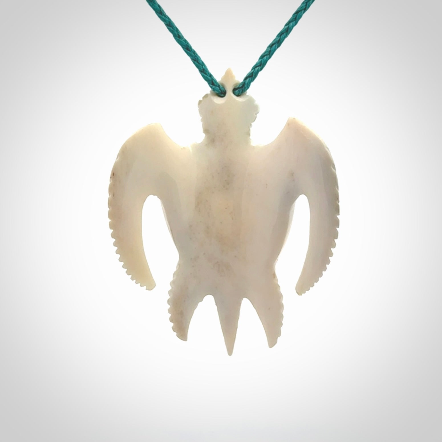 Hand carved bone turtle pendant. Delivered with an adjustable blue cord and packaged in a woven kete pouch.