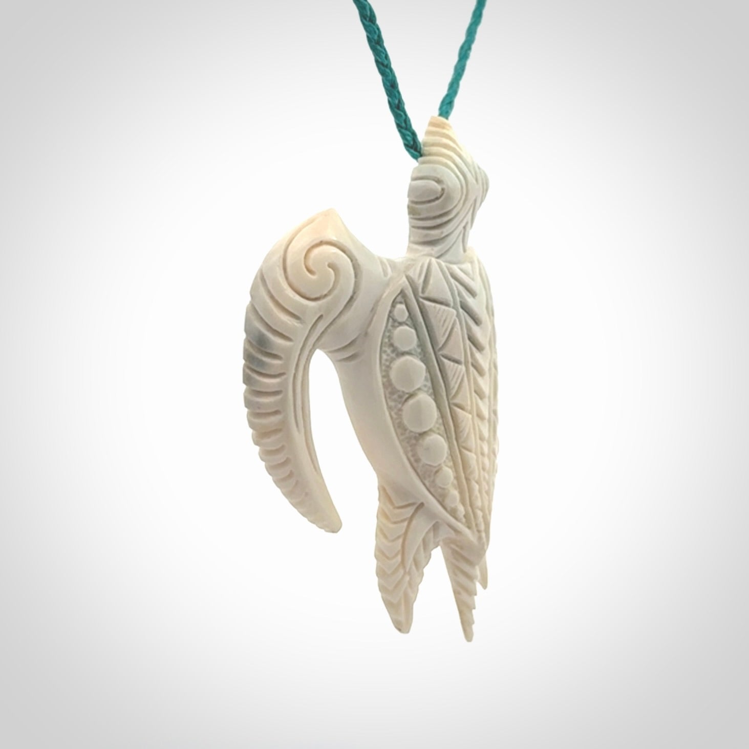 Hand carved bone turtle pendant. Delivered with an adjustable blue cord and packaged in a woven kete pouch.