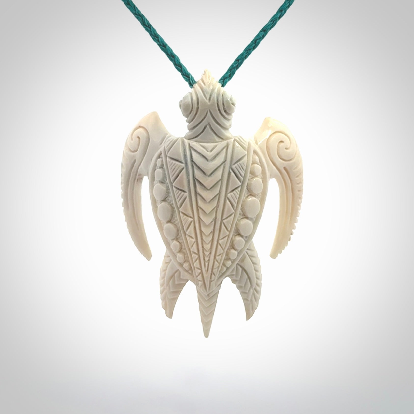 Hand carved bone turtle pendant. Delivered with an adjustable blue cord and packaged in a woven kete pouch.