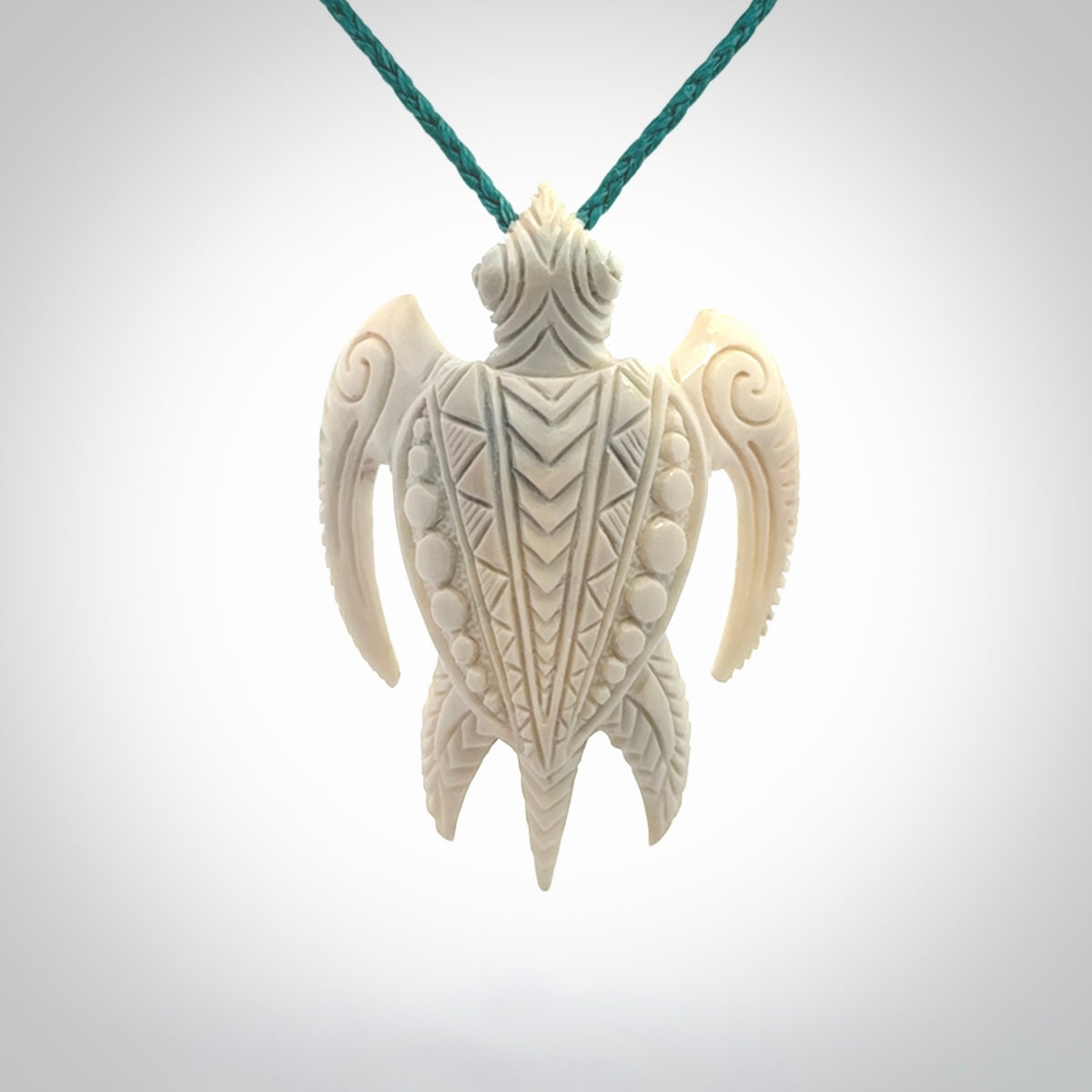 Hand carved bone turtle pendant. Delivered with an adjustable blue cord and packaged in a woven kete pouch.