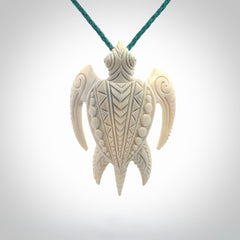 Hand carved bone turtle pendant. Delivered with an adjustable blue cord and packaged in a woven kete pouch.