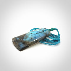 This picture shows a Labradorite stone toki pendant that we have hand carved.