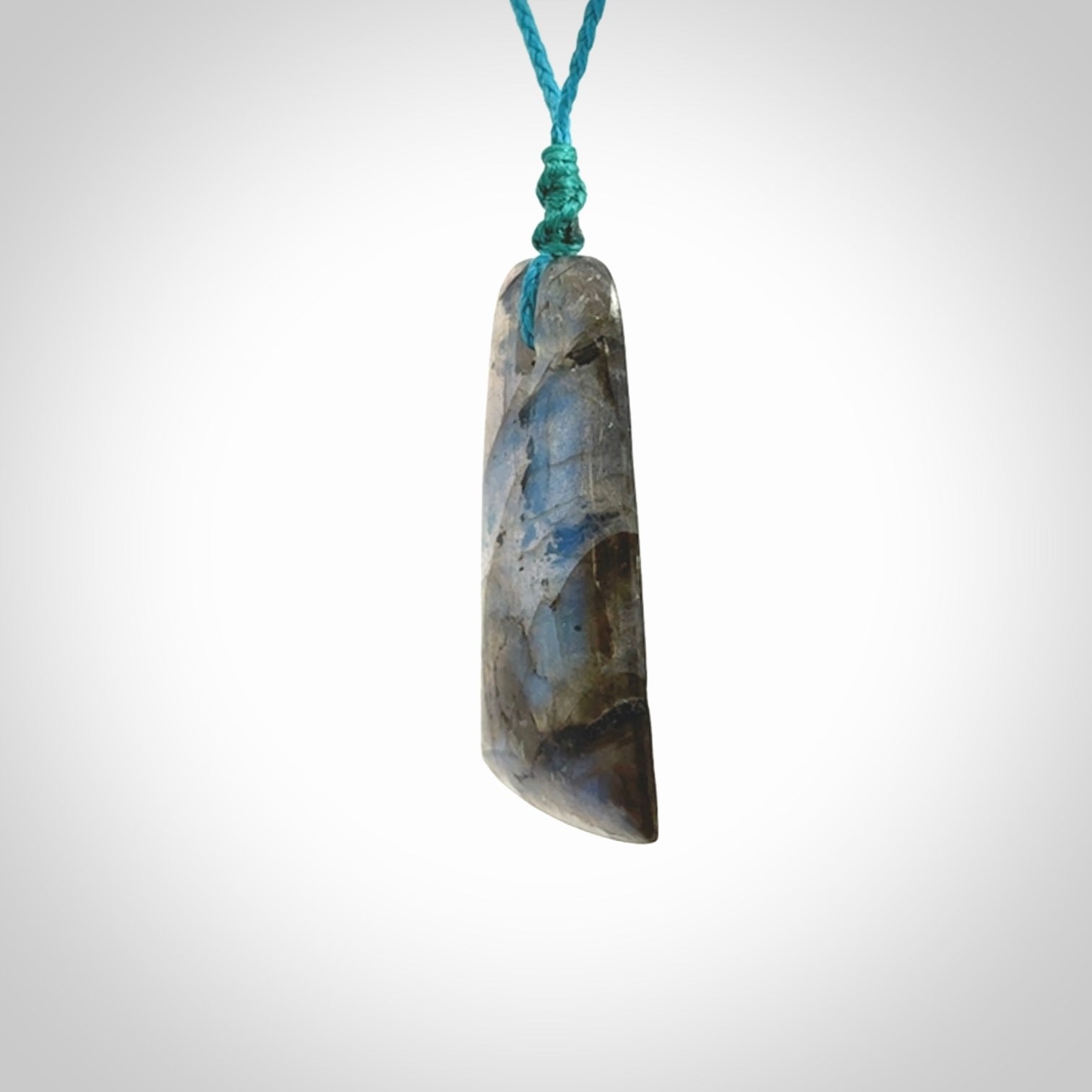 This picture shows a Labradorite stone toki pendant that we have hand carved.