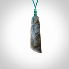 This picture shows a Labradorite stone toki pendant that we have hand carved.