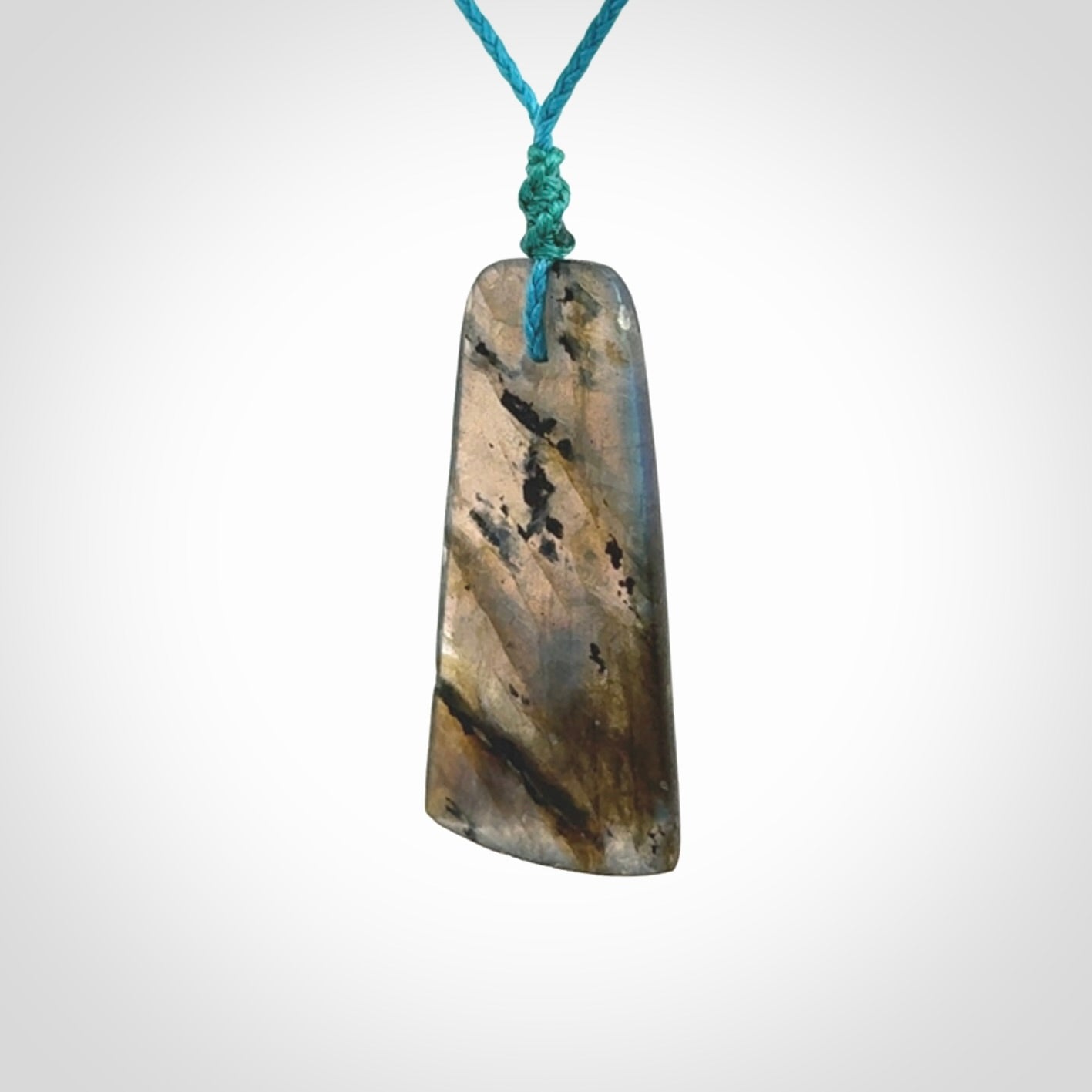 This picture shows a Labradorite stone toki pendant that we have hand carved.