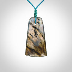 This picture shows a Labradorite stone toki pendant that we have hand carved.