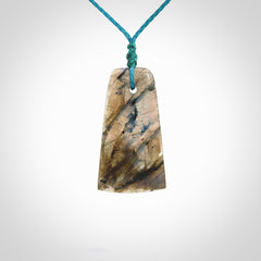 This picture shows a Labradorite stone toki pendant that we have hand carved.