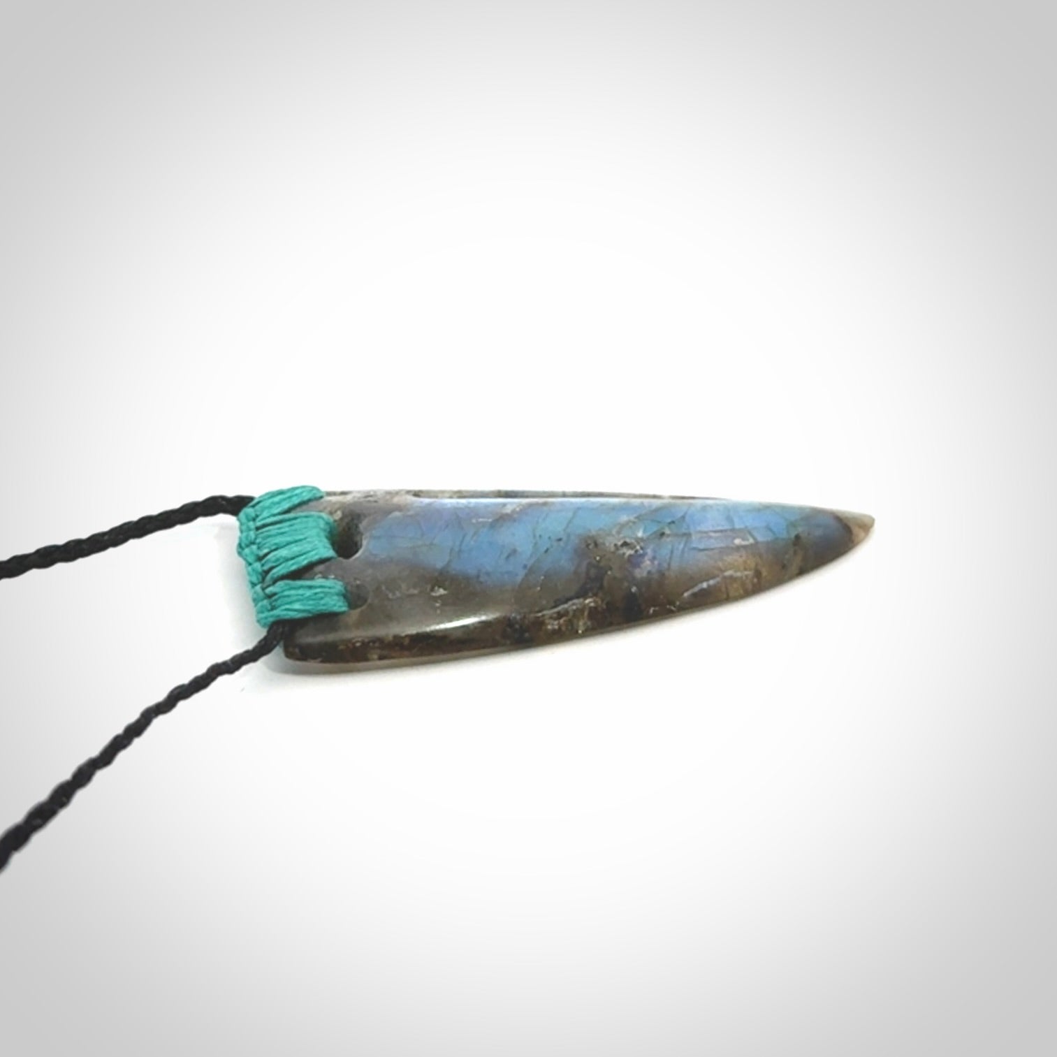This picture shows a Labradorite stone drop pendant that we have hand carved.