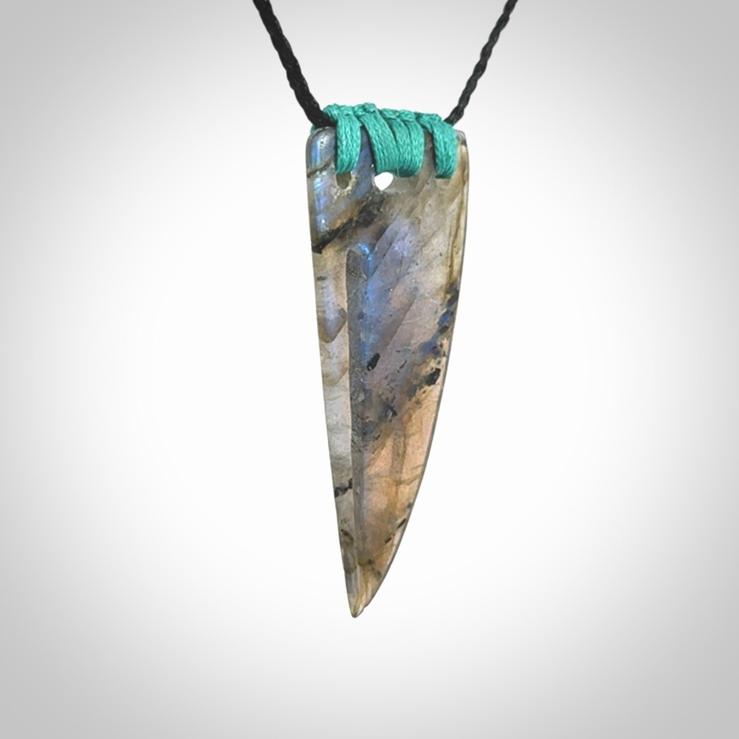 This picture shows a Labradorite stone drop pendant that we have hand carved.