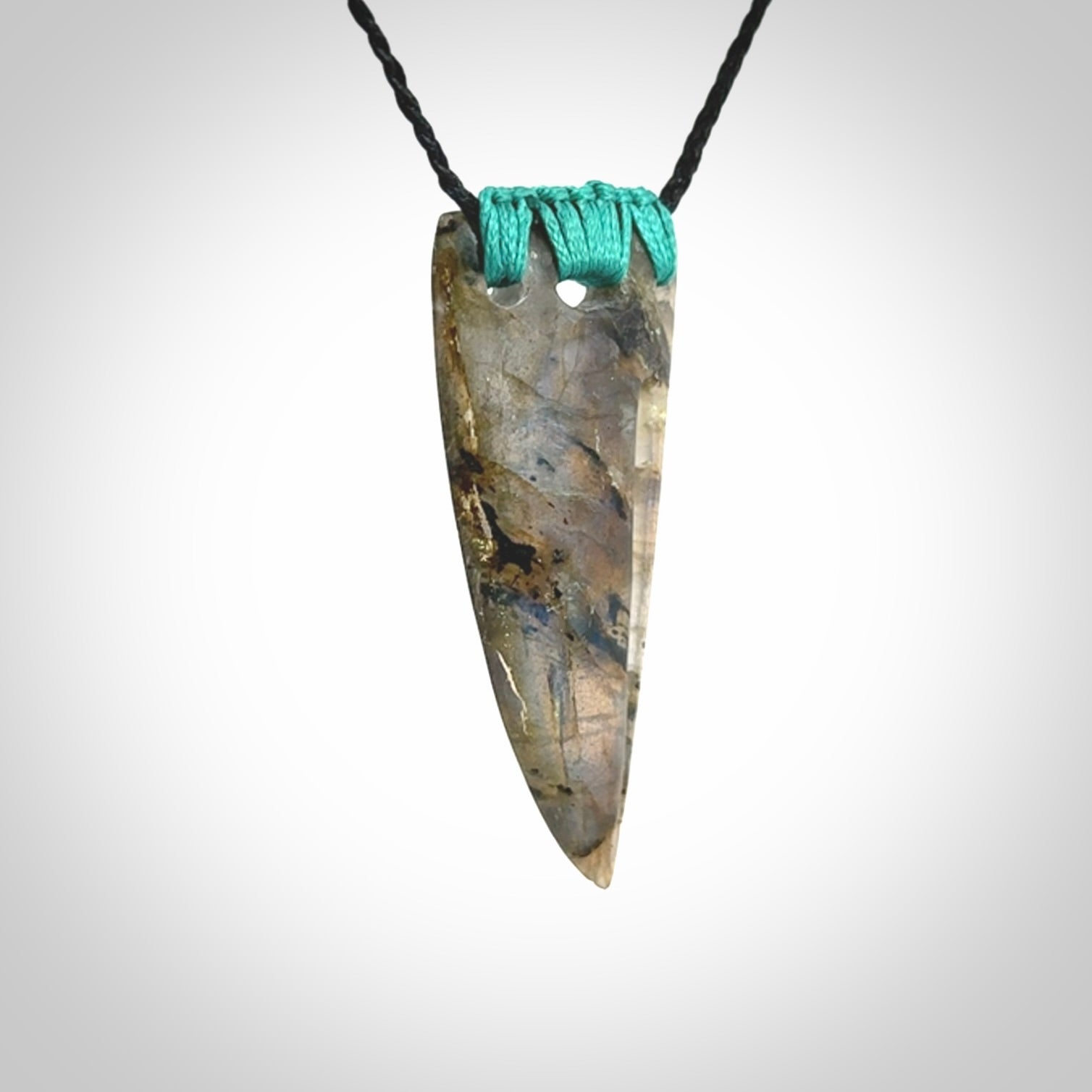 This picture shows a Labradorite stone drop pendant that we have hand carved.