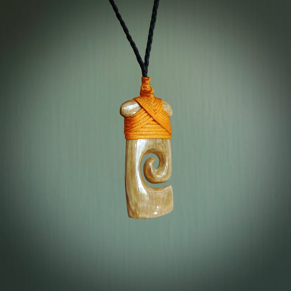 Hand carved Woolly Mammoth Tusk toki with koru pendant. Toki with koru necklace carved from ancient woolly mammoth tusk.