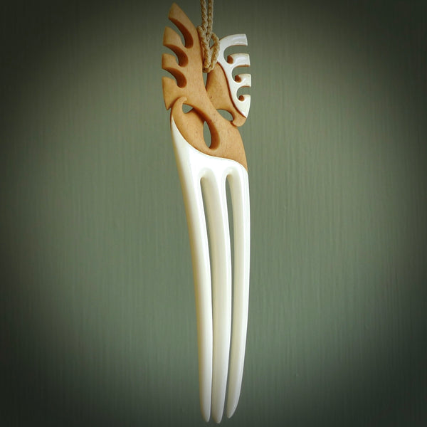 A hand carved bone and stained bone Heru comb. A large hand made Heru comb by New Zealand artist Kerry Thompson. Kerry has carved an exquisite work of art and would be perfect for an enthusiasts collection.