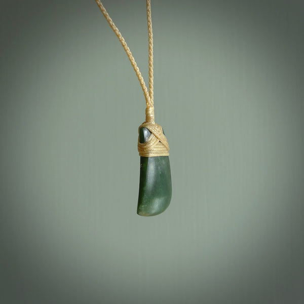 Hand carved jade toki by Ric Moor. Made in New Zealand by NZ Pacific. Hand carved Toki pendants crafted from beautiful New Zealand Pounamu, Jade. We deliver these with Express Courier, on adjustable cords.